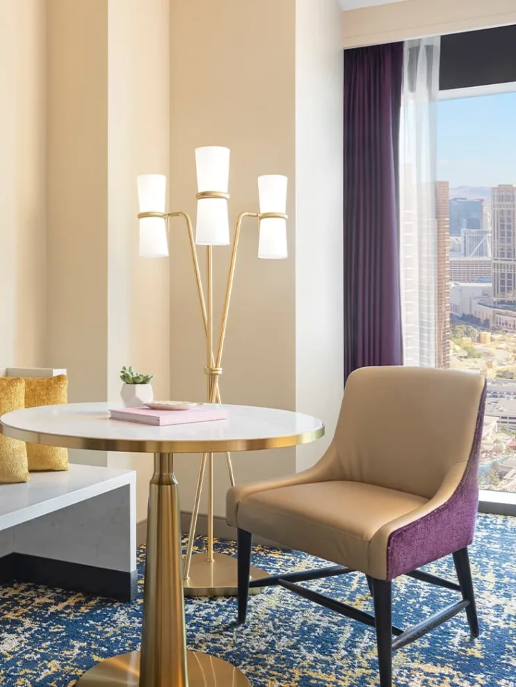 hilton hotel room with chair, table and a lamp